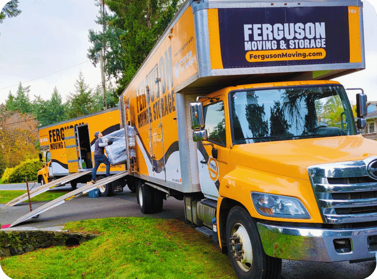 Mover loading wrapped furniture into a Ferguson moving truck during a residential move.