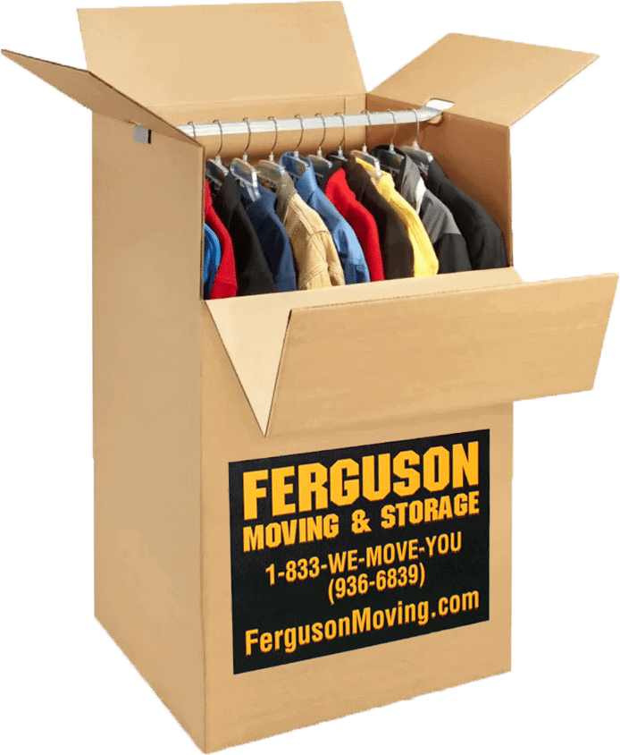 Clothes packed neatly inside a large wardrobe box during the packing process.