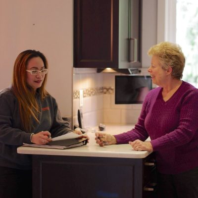 Dedicated Move Manager Ferguson Moving & Storage team member helping a senior client prepare for her move.