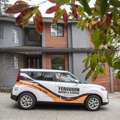 Ferguson Car By Home Ferguson vehicle parked outside a residential home during a local move.