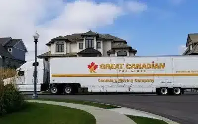 long-distance-moving-checklist-moving-day-qen Great Canadian Van Lines truck driving through a residential neighbourhood during a long distance move.